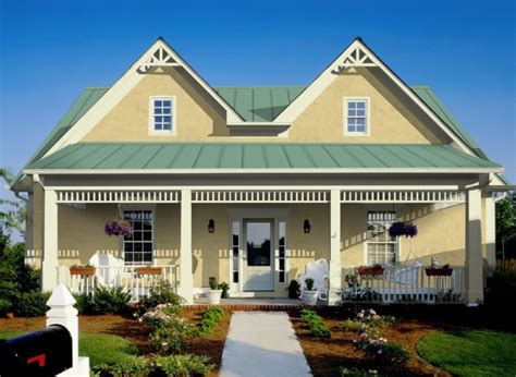 brick house with green metal roof and yellow door|metal green roof colors.